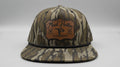 Camouflage baseball cap with a brand logo on a white surface