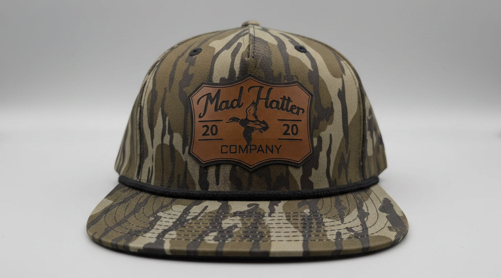 Camouflage baseball cap with a brand logo on a white surface
