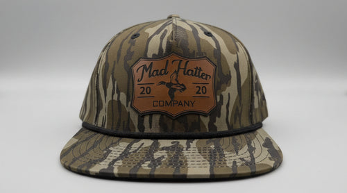 Camouflage baseball cap with a brand logo on a white surface