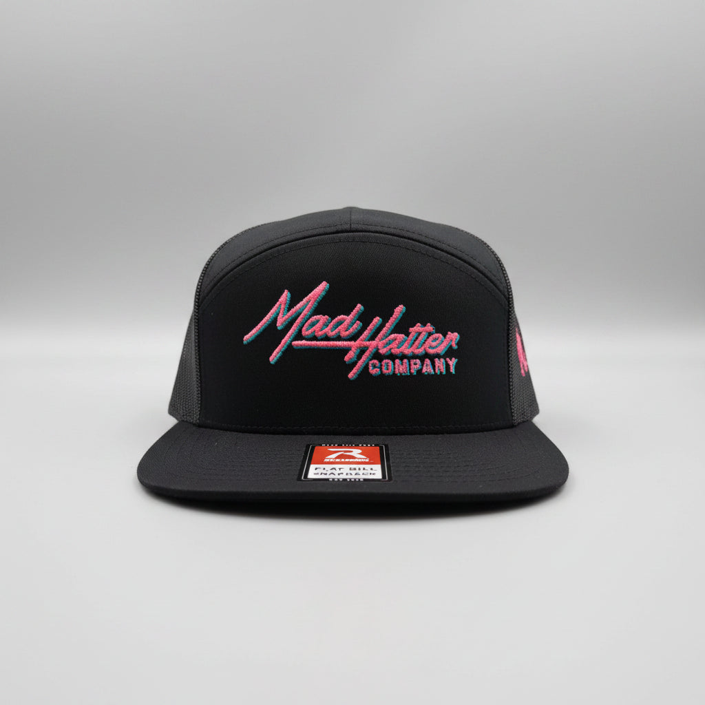 Black cap with 'Mad Hatter Company' logo on a white surface